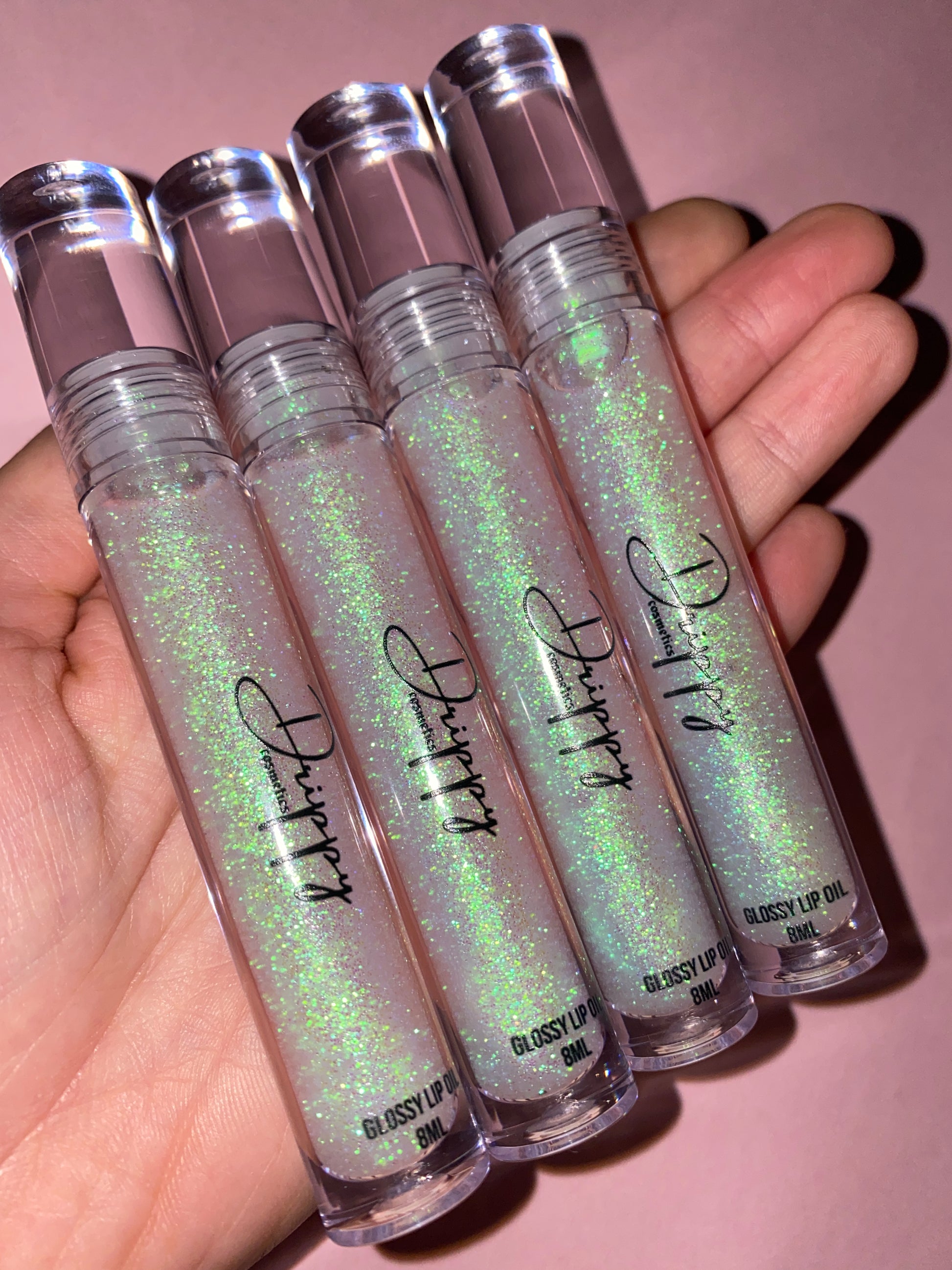 DRIPPY COSMETICSCoconut Sparkle Glossy Lip Oil
Not as thin as a lip oil &amp; not as thick and sticky as a Lip gloss. 
Our light-weight, silky formula gives you the shine of a Lip gloss with less stickiness and 