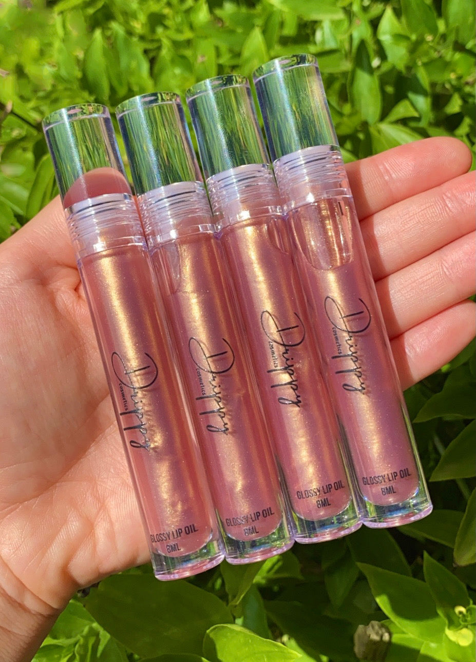 DRIPPY COSMETICSGolden Hour Glossy Lip OilNot as thin as a lip oil &amp; not as thick and sticky as a Lip gloss. 
Our light-weight, silky formula gives you the shine of a Lip gloss with less stickiness and m