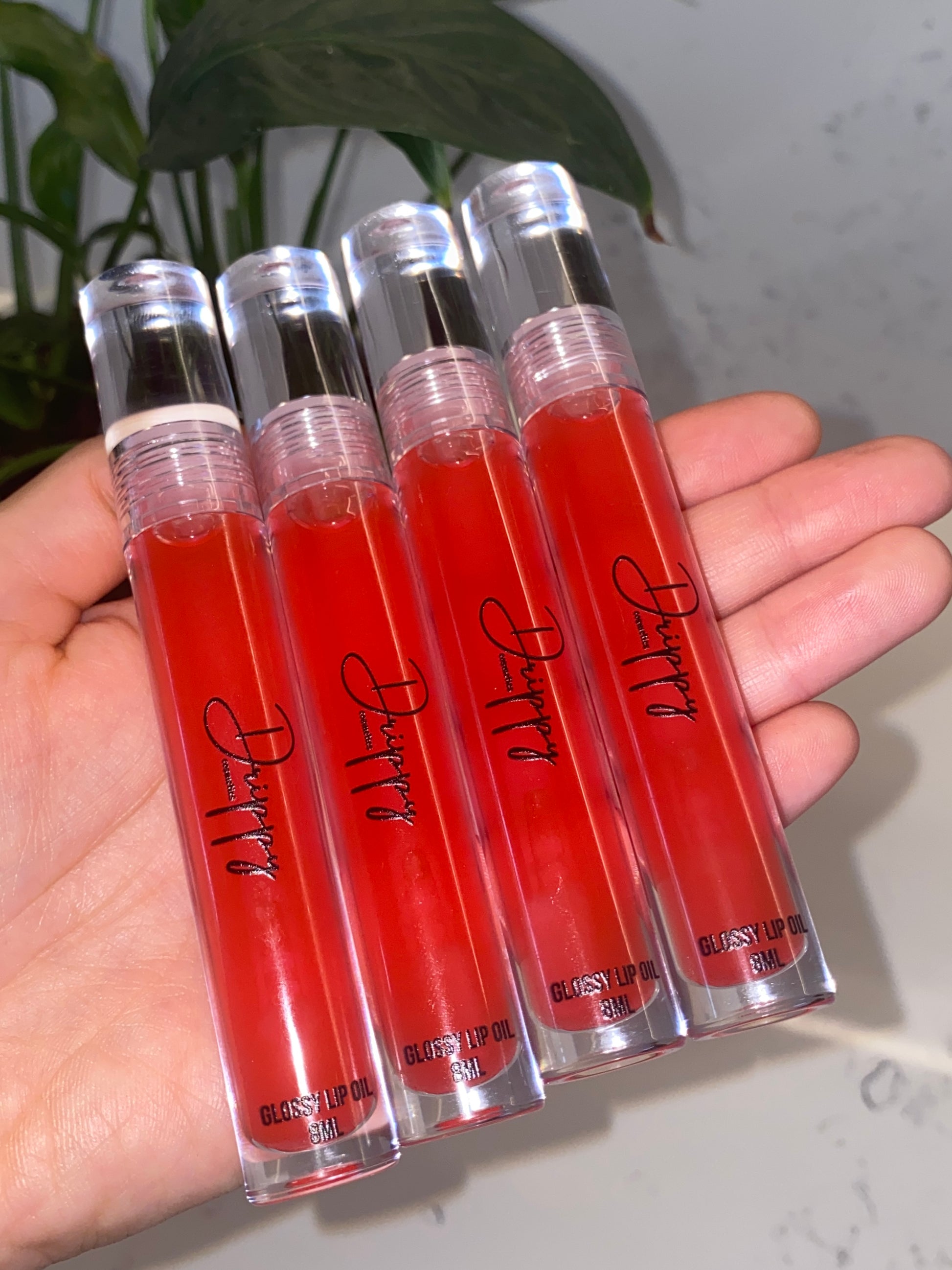 DRIPPY COSMETICSCherry Kisses Glossy Lip Oil

Not as thin as a lip oil &amp; not as thick and sticky as a Lip gloss. 
Our light-weight, silky formula gives you the shine of a Lip gloss with less stickiness and